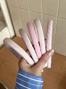 Detail view of 5-piece set of pink fabric headbands with grid and wave patterns