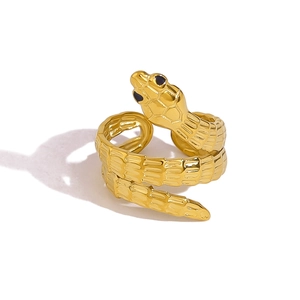 Macro detail showing textured snake scales and golden finish on the polished serpent ring