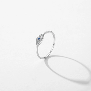 S925 sterling silver Evil Eye ring with blue gem and white zircon accents on light background