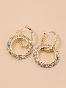Detailed view of gold double hoop earrings with pave-set shimmering crystals
