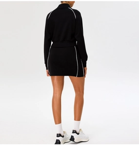 Detail view of the back of a slim-fit black yoga set with white side stripe accents