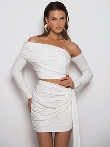 Elegant white two-piece set with off-shoulder long sleeve top and ruched mini skirt