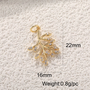 Macro shot of 22mm x 16mm gold branch pendant with cubic zirconia leaf details