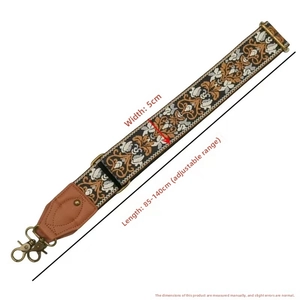 Close-up of 5cm ethnic embroidered guitar strap with bronze hooks and leather ends