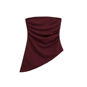 Detail of burgundy tube top showing ruched side texture and asymmetrical hemline design
