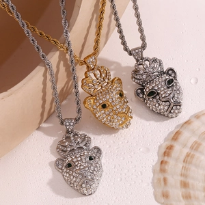 Detail view of 18K gold and silver hip hop crown leopard pendants with rope chains
