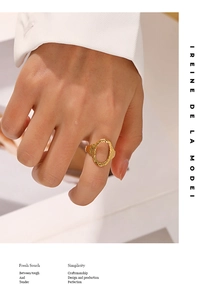 Detail of adjustable gold hollow ring with hammer-textured finish on a female finger