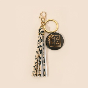 Close-up of leopard print tassel keychain with gold MAMA engraved round wooden charm