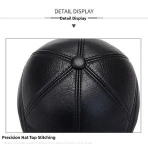 Detailed top view of the black faux leather cap showing stitching and lychee texture