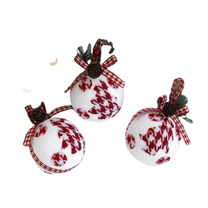 Three-piece red and white houndstooth Christmas ball ornaments with pine cones and needles