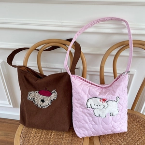 Detailed embroidery of cute poodles on quilted heart corduroy bags in brown and pink