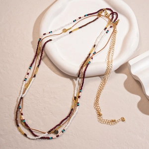 Detail of bohemian layered waist chain with colorful glass beads and gold metal sequins