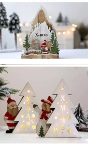 Close-up of wooden glowing Santa Claus tree ornament with X-mas cutout lettering