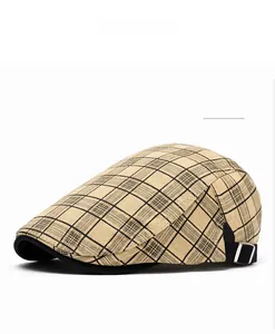 Detail of camel plaid cotton newsboy hat showing fabric texture and metal side buckle