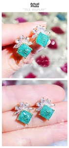 Macro shot of square green zircon earrings with marquise stones and gold plating