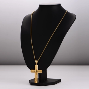 Vintage golden 3D cross pendant necklace displayed on a black mannequin neck stand