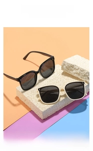 Gros plan de lunettes de soleil carrées pour enfants en noir et crème avec rivets