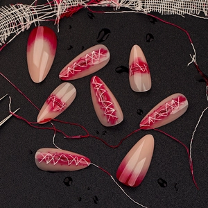 3D gradient Halloween stiletto fake nails with zombie stitch design on dark background