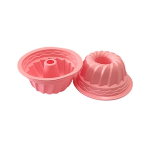 Detail view of pink silicone cake molds featuring spiral textures and center chimney column