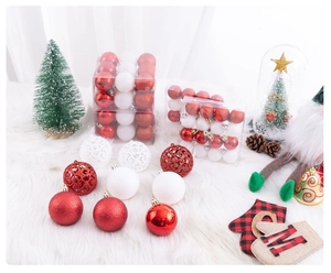 Detail view of assorted red and white Christmas ball ornaments with glitter and hollow designs
