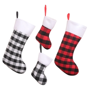 Set of four red and black buffalo plaid Christmas stockings in large and small sizes