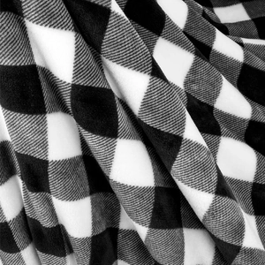 Macro detail of soft black and white buffalo plaid sherpa flannel fabric texture