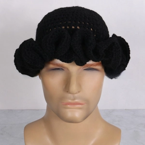 Detail of black handmade crochet ruffled hat showing intricate knit pattern and wavy edge