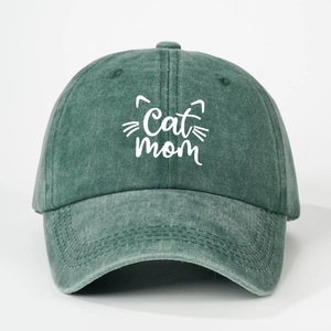 Detail of white Cat Mom embroidery and kitten whiskers on vintage washed green cotton cap