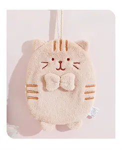 Detail of light brown cat-shaped hand towel with soft coral fleece texture and bow