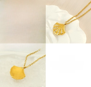 Detail of 18K gold plated stainless steel shell pendant with sparkling crystal inlay