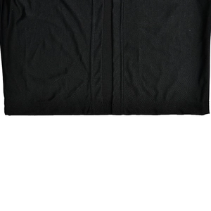 Detailed close-up showing the precise stitching and fabric texture of the black dress hem