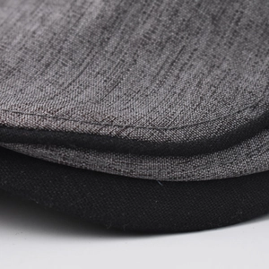 Macro shot of cotton beret showing precision stitching and gray fabric texture