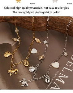 Détail macro de pendentifs crabe et coquillage sur une chaîne trombone or et argent