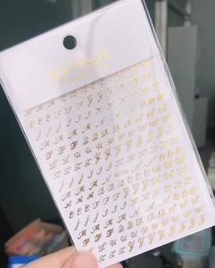 Detail shot of WG720 golden 3D nail art stickers with A-Z vintage alphabet design