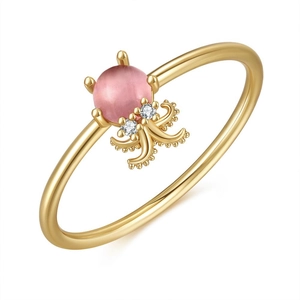Macro shot of 18K gold octopus ring featuring a pink opal stone and crystal details