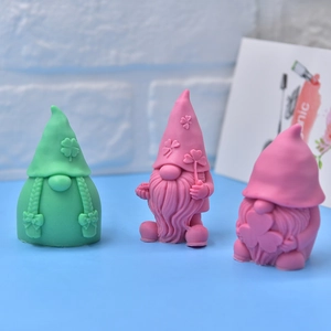 Three gnome silicone molds in green and pink with clover details for DIY candles