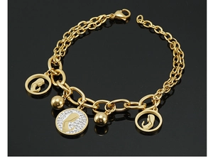Macro view of 18K gold plated stainless steel bracelet with crystal portrait pendant