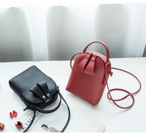 Mini PU leather crossbody bags in red and black colors with long shoulder straps and zippers