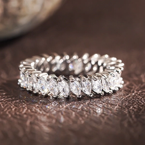 Macro shot of silver eternity ring with marquise cut stones and claw settings