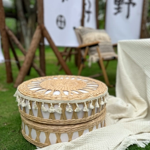 Handwoven straw tatami floor cushion with white fringe trim for bohemian outdoor camping style