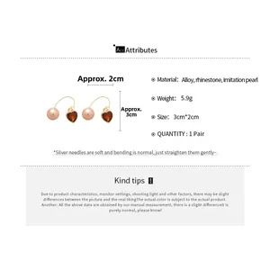 Détails des boucles d'oreilles cœur et perle avec dimensions de 3cm et poids de 5,9g