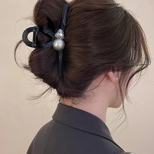 Elegant shark hair claw with rhinestones and pearl detail shown on model back view