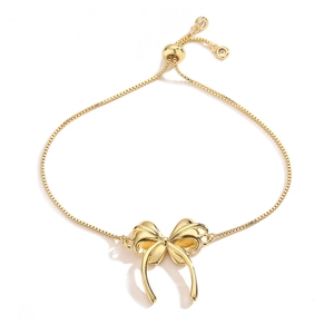 Detailed view of gold plated bow bracelet with adjustable slider clasp and sparkling zircon