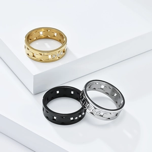 Three minimalist stainless steel rings in gold black silver with Roman numeral cutouts