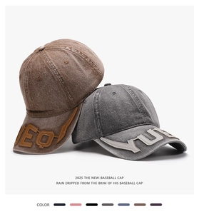 Detail of washed cotton baseball caps showing 2025 vintage texture and letter patches