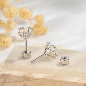 DIY silver hollow heart-shaped screw-back earring studs with retro floral background