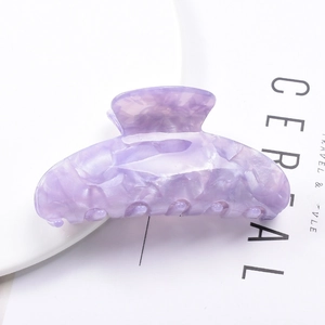 Detail of purple marble pattern acetate hair claw clip with natural swirl texture