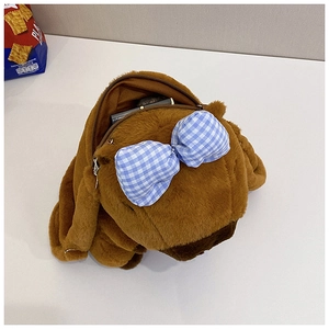 Detail showing the inner storage space of a plush brown Capybara backpack with blue bow