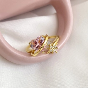 Detail of 18k gold plated open ring with pink heart zircon and star accents