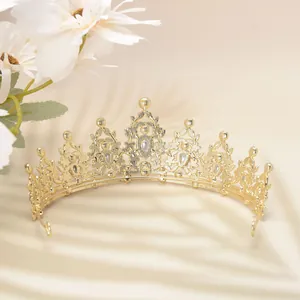 Detailed view of luxury gold hollow crown with water-drop crystals and floral shadows